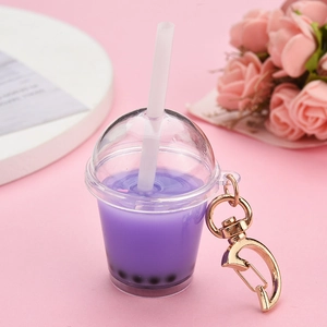 Detail of creative purple taro bubble tea keychain with gold moon-shaped spring clasp