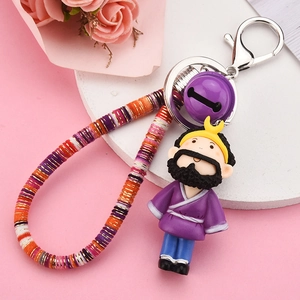 Detail of cartoon Sha Seng keychain with purple monk robe and colorful woven lanyard