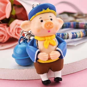 Cute cartoon pig keychain with blue hat and bell, perfect for backpack decoration