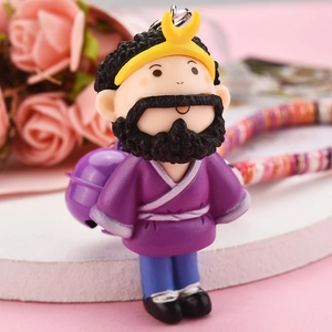 Macro view of purple cartoon monk key chain with metal bell and woven lanyard accessory