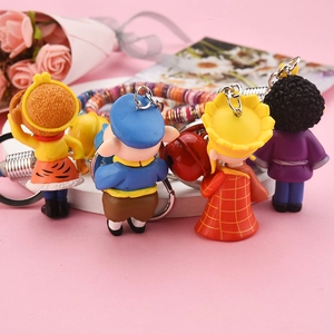 Detail view of colorful Journey to the West cartoon character keychains with beaded straps