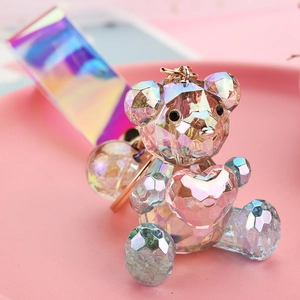 Close-up of faceted acrylic colorful bear with heart and iridescent laser wrist strap