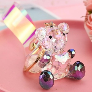 Macro view of faceted iridescent crystal bear keychain with heart and aurora strap
