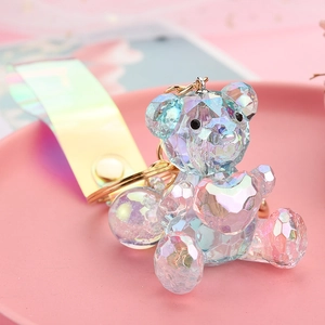 Detailed macro of a vibrant acrylic faceted bear keychain with iridescent heart charm