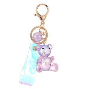 Colorful acrylic teddy bear keychain with faceted purple crystal design and hand strap
