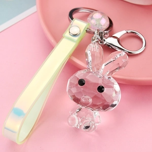 Detail of faceted acrylic bunny keychain with iridescent strap and silver hardware