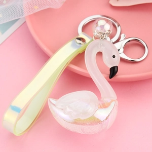 Close-up of iridescent swan acrylic keychain with pearlescent finish and PVC strap