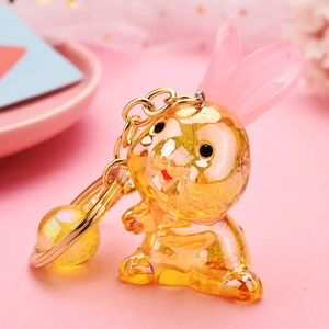 Porte-clés lapin en acrylique coloré avec détails en feuilles d'or et oreilles roses translucides