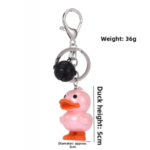 Pink cartoon duck keychain with black bell showing detailed 12cm dimensions on white background