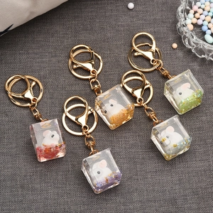Set of five cute white mouse resin cube keychains with colorful glitter and gold hooks