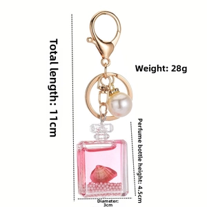 Pink ocean perfume bottle keychain with acrylic shell, pearls and liquid detail