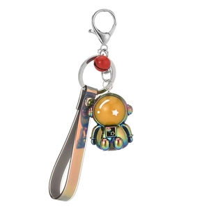 Creative astronaut keychain with metallic finish, rainbow strap, and red bell accessory