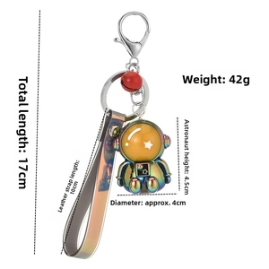 Iridescent astronaut keychain details with 17cm total length and red bell attachment