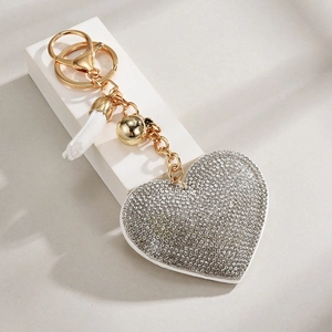Golden heart keychain with sparkling silver rhinestones, white tassel and small gold bell