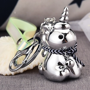 Close-up of silver unicorn keychain with translucent green strap and tiny bell detail