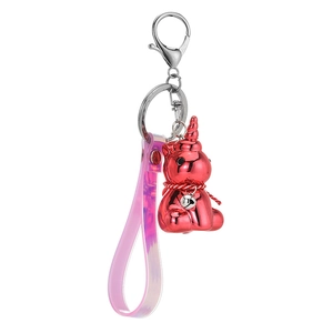 Creative unicorn keychain with red metallic pendant and pink iridescent wrist strap