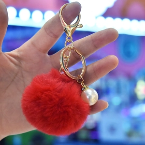 Red faux rabbit fur pom pom keychain with gold lobster clasp and pearl charm accessory