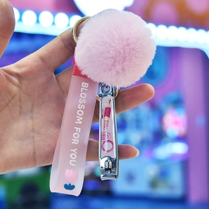 Pink plush pom-pom keychain with nail clipper and silicone wristlet strap for bags