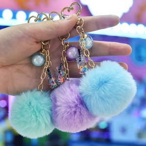 Three-piece faux rabbit fur pom pom keychains with golden heart rings in multiple colors