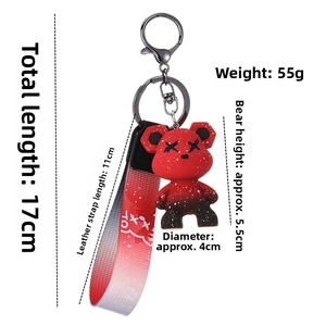 Detail of red and black gradient acrylic bear keychain showing dimensions and X-eye style