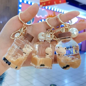 Bubble tea bear keychain featuring acrylic liquid sand bottle with faux pearl charm