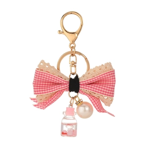 Fashionable alloy keychain with pink plaid bow, lace trim, glass vial and pearl pendant