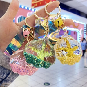 Close-up of colorful acrylic shell keychains with liquid glitter and laser straps