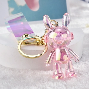 Macro detail of aurora pink acrylic bunny keychain with iridescent resin finish