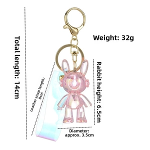 Detailed view of iridescent pink bunny keychain with size dimensions and gold carabiner