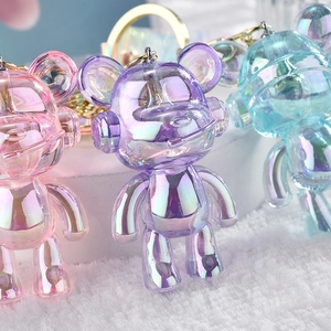 Colorful acrylic bear keychains with iridescent finish in pink, purple, and blue styles