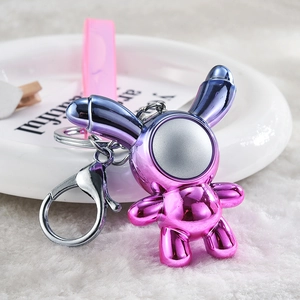 Detail of creative iridescent rabbit keychain with pink strap and silver metal clasp