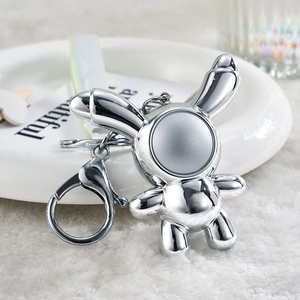 Detail of silver iridescent space rabbit keychain with mirrored metallic finish
