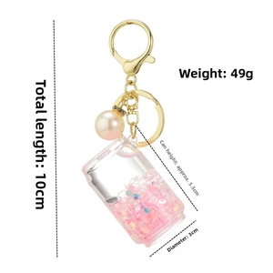 Detailed view of liquid quicksand keychain dimensions with golden lobster clasp and pearl