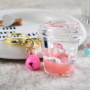 Detailed view of pink acrylic coffee cup keychain with liquid glitter and small pig
