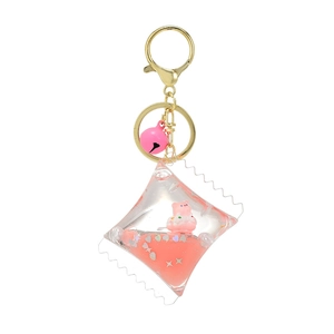 Acrylic quicksand keychain featuring a cute pink pig, stars, and bell on a white background