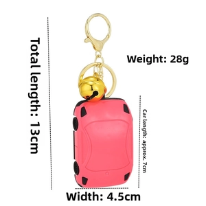 Pink car-shaped calculator keychain with gold bell and dimensions 13cm x 4.5cm
