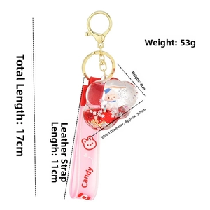 Detail view of pink cloud drifting bottle keychain with small sheep and star sequins inside