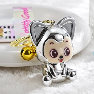 Detailed macro view of electroplated silver fox keychain with gold bell and ring