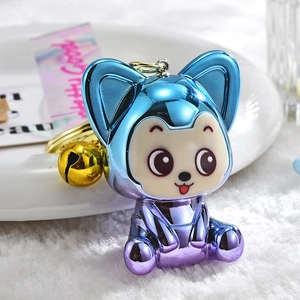 Cute gradient blue acrylic fox keychain with gold bell on white plush background