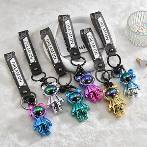 Plated astronaut bear keychains in six metallic colors with black Dream On wrist straps