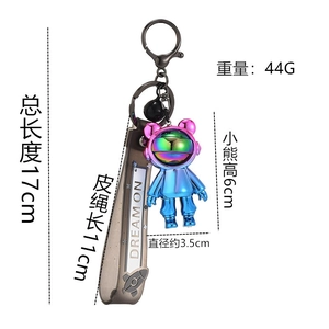 Detail of space astronaut bear keychain with gradient plating and dream on leather strap