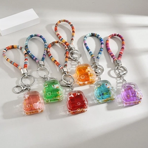 Set of six colorful backpack liquid sand keychains with mini ducks and sequins