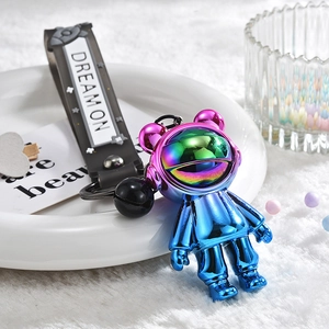 Detail of gradient astronaut keychain with black Dream On wrist strap and small bell