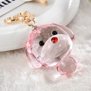 Detail of pink crystal puppy charm with rhinestone eyes and a golden heart clasp