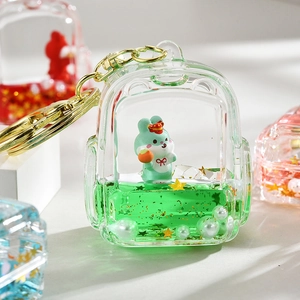 Cute acrylic backpack keychain with mini rabbit doll and green liquid glitter charm