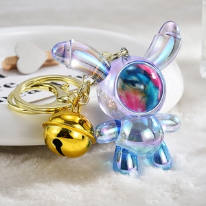 Holographic gradient astronaut rabbit keychain with a golden bell on white fur