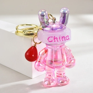 Detail of a pink pearlescent gradient rabbit keychain with China text and golden ring