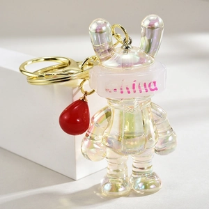 Close-up of a gradient acrylic bunny keychain with pearlescent finish and golden metal ring
