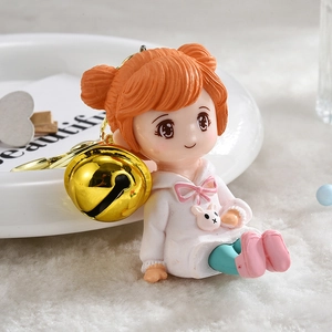 Cute resin hoodie girl keychain with orange buns, golden bell, and metal clip accessory