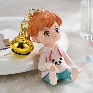 Cute boy figurine keychain in pink panda hoodie with large golden bell accessory
